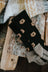 Men’s black merino wool socks with embroidered gold bear faces and gray ribbed cuffs for soft comfort