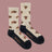 Heathered beige men’s bison merino wool socks with brown prints and black toe and heel from friday sock co for hiking