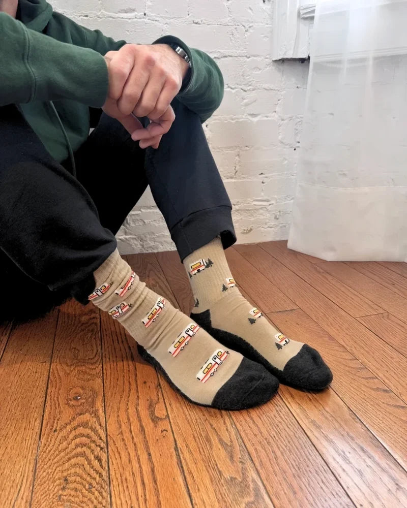 Beige merino wool socks with black toe and heel featuring a vintage train pattern perfect for warmth and breathability