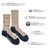 Beige and navy blue merino wool socks with vintage camper pattern and friday sock co branding on the heel