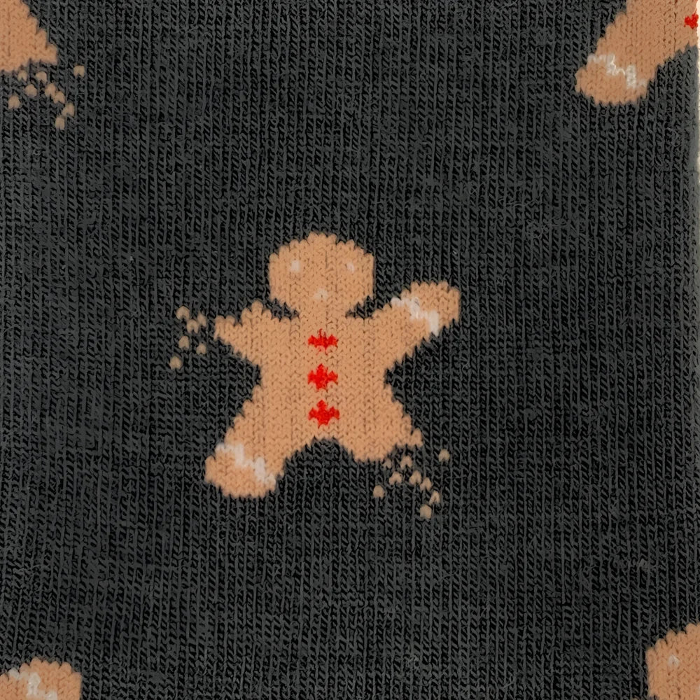Dark gray merino wool socks with tan gingerbread man and red icing details for outdoor cozy wear