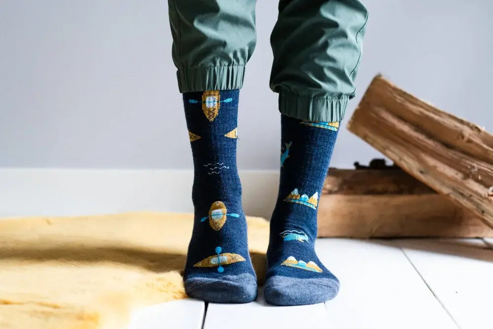 Dark blue merino wool socks with playful gold and light blue space patterns perfect for outdoor activity
