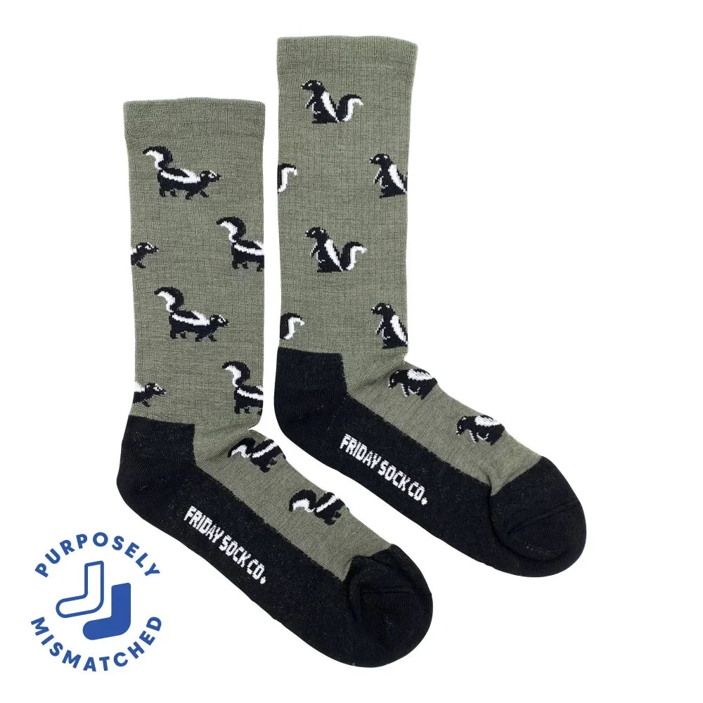 Olive green merino wool socks with black and white skunk patterns and black toe and heel by friday sock co