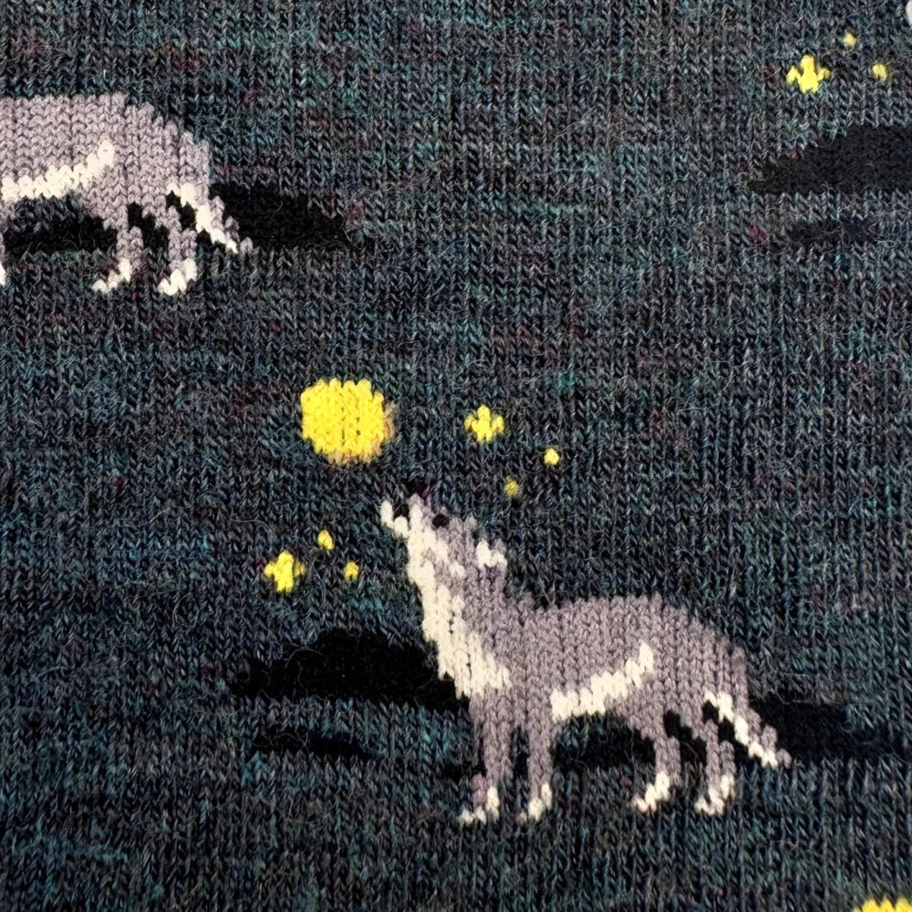 Dark green merino wool socks with embroidered gray and white wolves and yellow stars for warm breathable wear