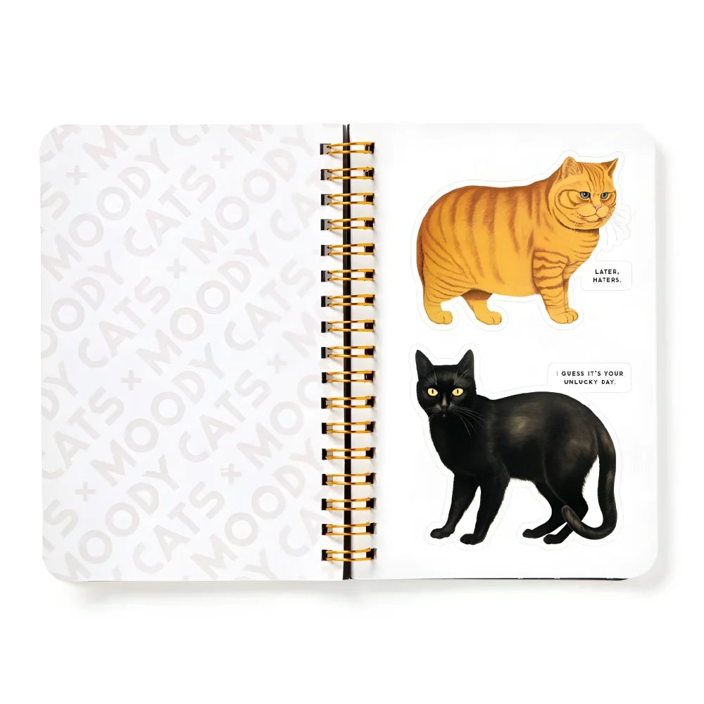 Open spiral-bound sticker book featuring colorful cats sticker illustrations from moody cats sticker book