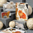 A spiral-bound cats sticker book titled moody x cats featuring colorful illustrations of various cat breeds on the cover