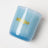 A translucent light blue glass jar candle with gold mikjar logo moonrise neroli plum coconut soy 8oz candle