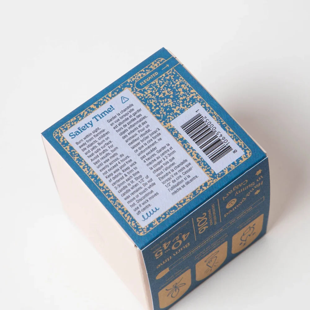 Back of blue and gold moonrise neroli plum coconut soy 8oz candle box with safety instructions and product info