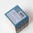 Back of blue and gold moonrise neroli plum coconut soy 8oz candle box with safety instructions and product info