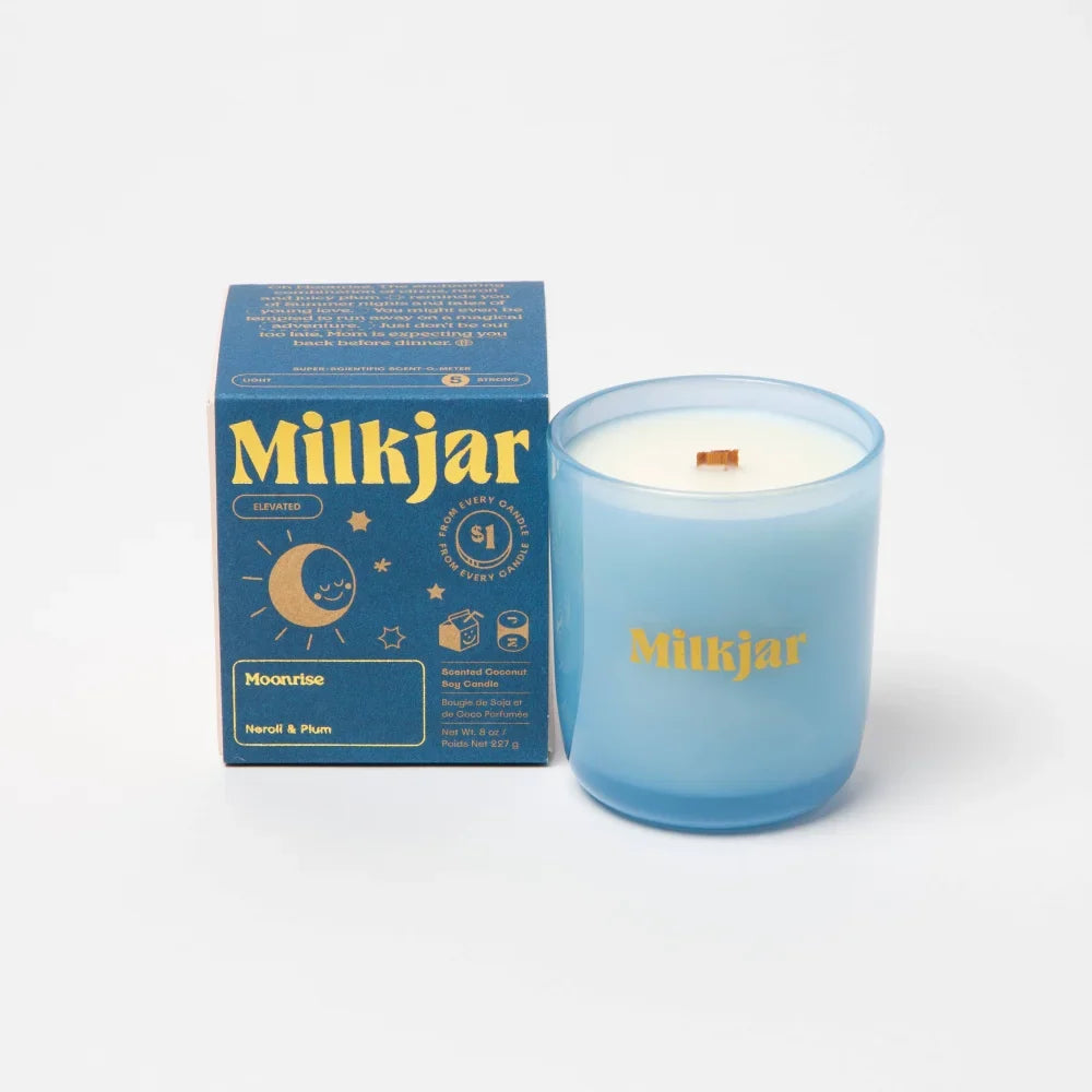 Translucent light blue coconut soy milkjar candle with wooden wick and gold lettering in moonrise neroli plum scent