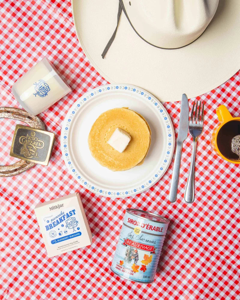 Golden pancake with butter on a white plate with blue floral trim featured on a pancake breakfast 8oz soy candle
