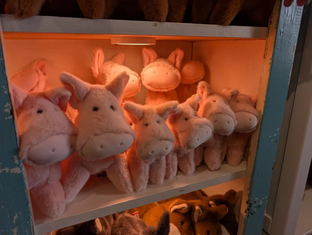 Pink piggies large size plush pig toys neatly arranged on shelf soft and cuddly stuffed animals
