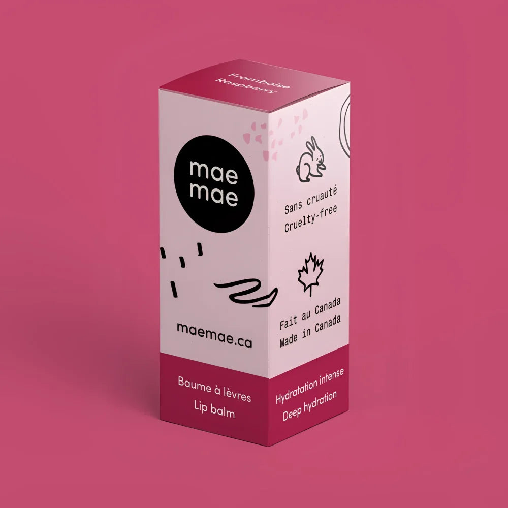 Pink and white rectangular box of mae mæ raspberry natural lip balm with black text and illustrations for lip balms use