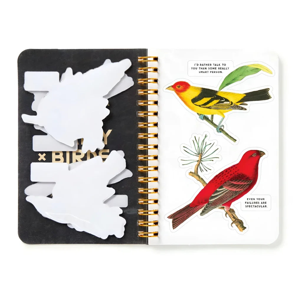 Black spiral-bound sticker book with gold binding featuring colorful shady birds stickers and white die-cut shapes pages