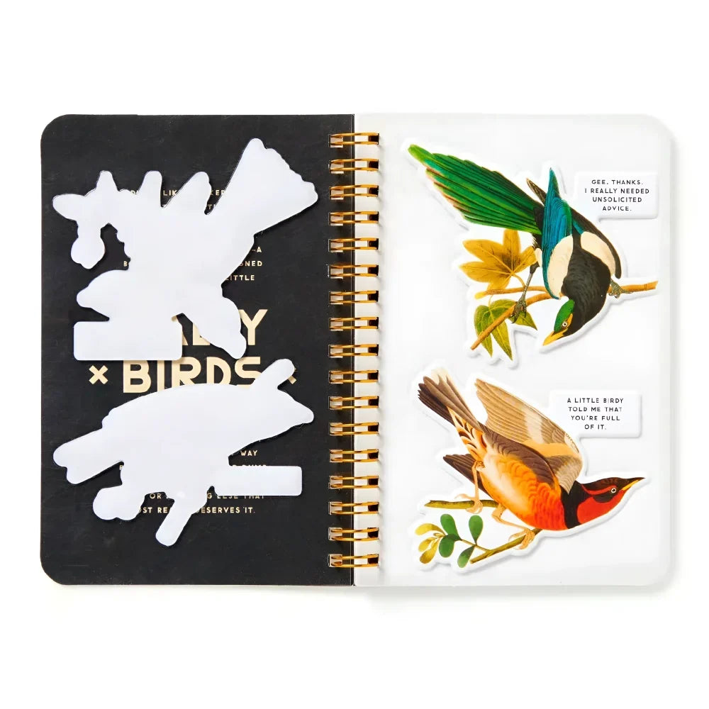 Open spiral-bound salty birds sticker book with black and white pages and gold binding featuring bird-themed stickers