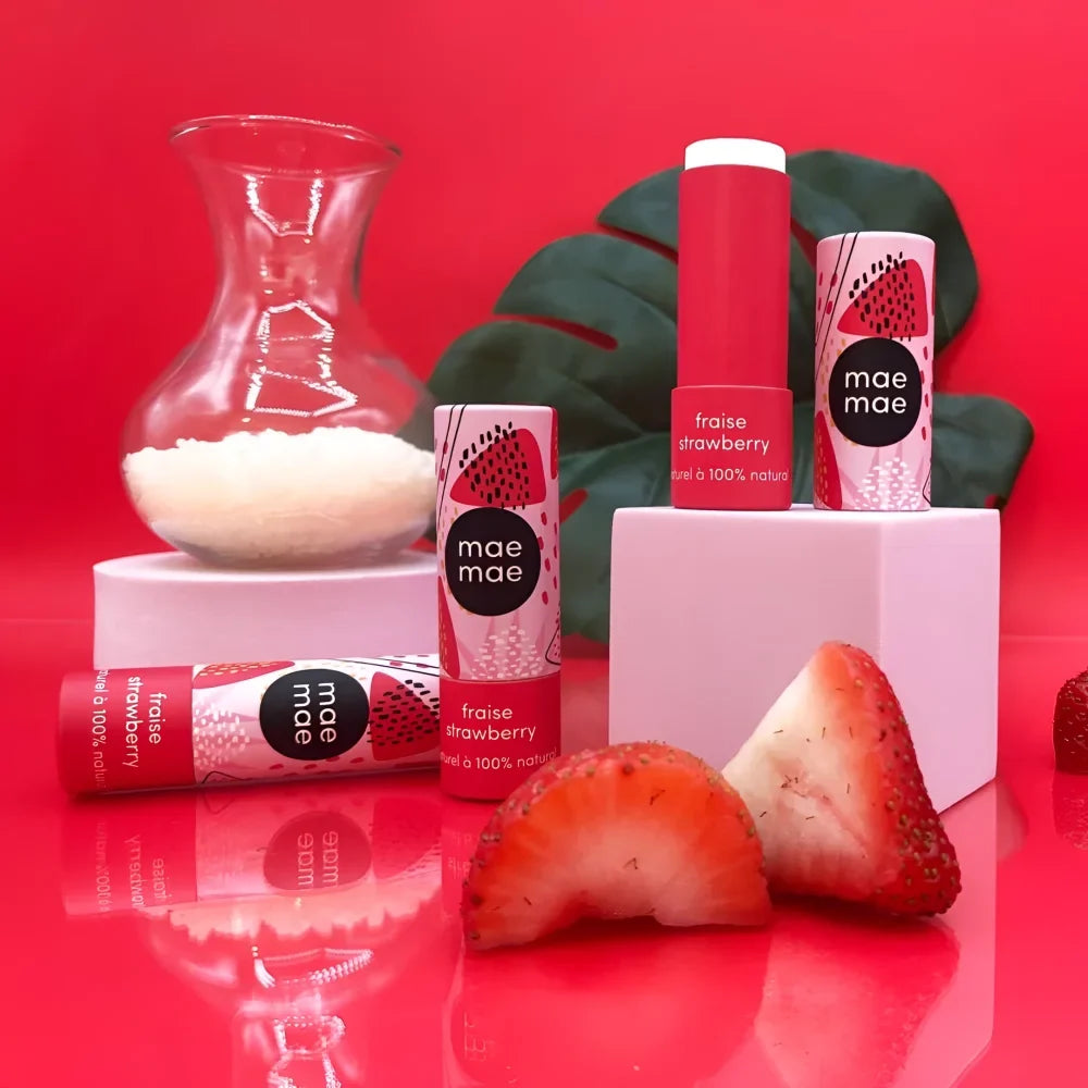 Red and pink mae mae strawberry natural lip balm tubes with playful sliced strawberry design lip balms