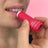 A vibrant red cylindrical strawberry scented lip balm tube with a white cap and minimalist branding for lip balms