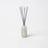 A sleek translucent light blue glass reed diffuser bottle with gray reeds for pear and nectarine diffuser smells