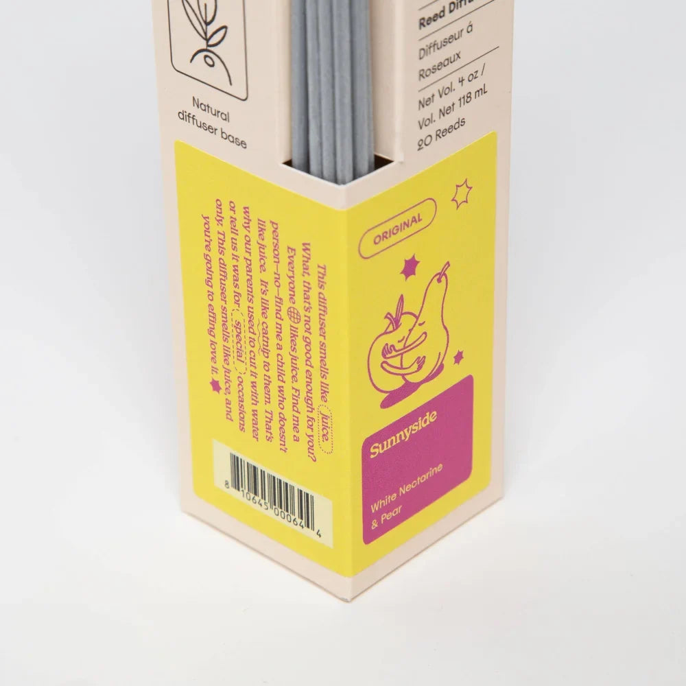 Yellow and pink cardboard box with 20 gray reed diffuser sticks for sunnyside pear and nectarine diffuser smells