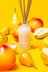 A frosted white glass reed diffuser bottle with metal reeds and milkjar logo featuring pear and nectarine diffuser smells