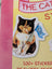 A calico cat sticker with a stern look holding a blue nope flag on yellow background from megan lynn kott