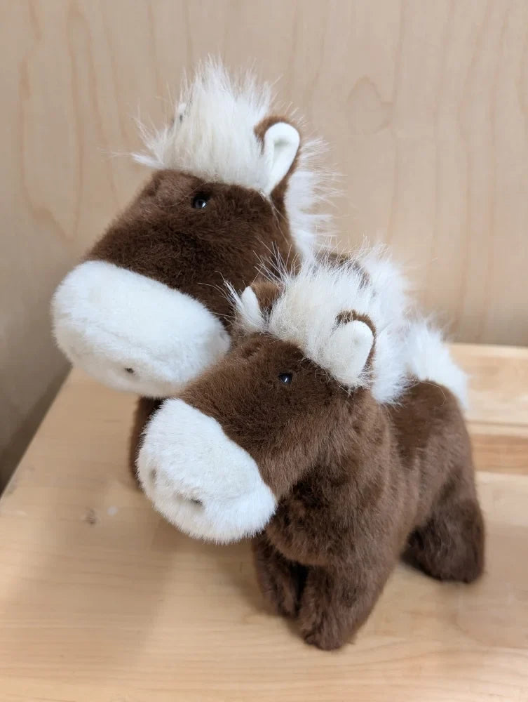 Two plush brown and white stuffed ponies with fluffy manes from the pony collection perfect for kids playtime