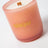 A peach-colored frosted glass milkjar coconut soy candle with wooden wick labeled wallflower tobacco and peony