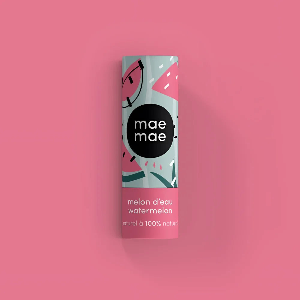 A cylindrical tube of mae mae watermelon flavored natural lip balm with mint green and pink cartoon watermelon design