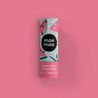 A cylindrical tube of mae mae watermelon flavored natural lip balm with mint green and pink cartoon watermelon design