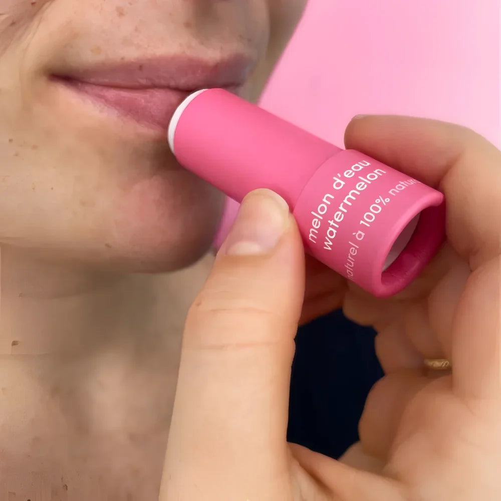 Pink cylindrical watermelon natural lip balm tube with white text and matching pink cap for lip balms use