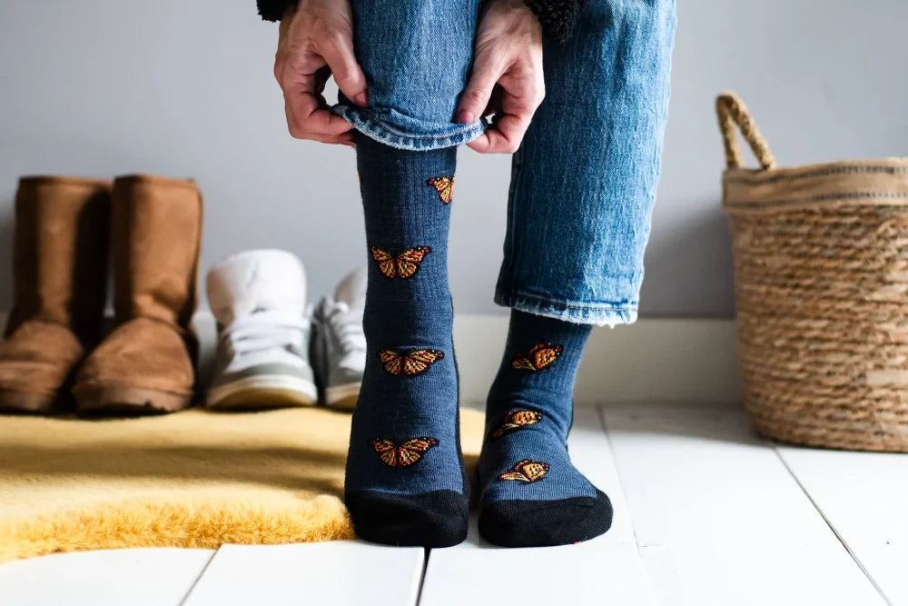 Blue womens merino wool socks with orange monarch butterfly patterns comfy wool socks for hiking