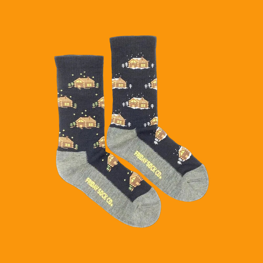 Black and gray women’s cabin merino wool socks with pixelated cozy cabins snow trees and stars by angus oliver