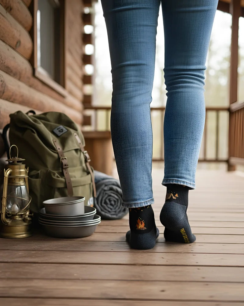 Back of black women’s camping at night merino wool socks with flame design and thorntons logo for outdoor coziness