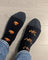 Women’s camping at night merino wool socks in black with gray toes and pixelated orange pumpkin designs by angus oliver