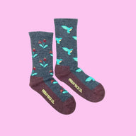 Dark gray heathered women’s merino wool socks with turquoise hummingbirds red flowers and maroon toe caps and heels