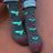 Dark gray merino wool socks with turquoise yellow hummingbirds red flowers and maroon toe caps in a fun knit pattern