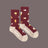 Women’s maroon merino wool socks with yellow mushroom and white snail pattern and beige toe and heel for comfy hiking
