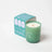 Woodland essential oil coconut soy candle in translucent green glass with white wax and orange wick featuring tree stump design