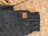 Dark gray knitted fingerless glove with brown leather patch and ark logo, perfect alongside your woolen calgary cardigan with attached hood made from zealand wool