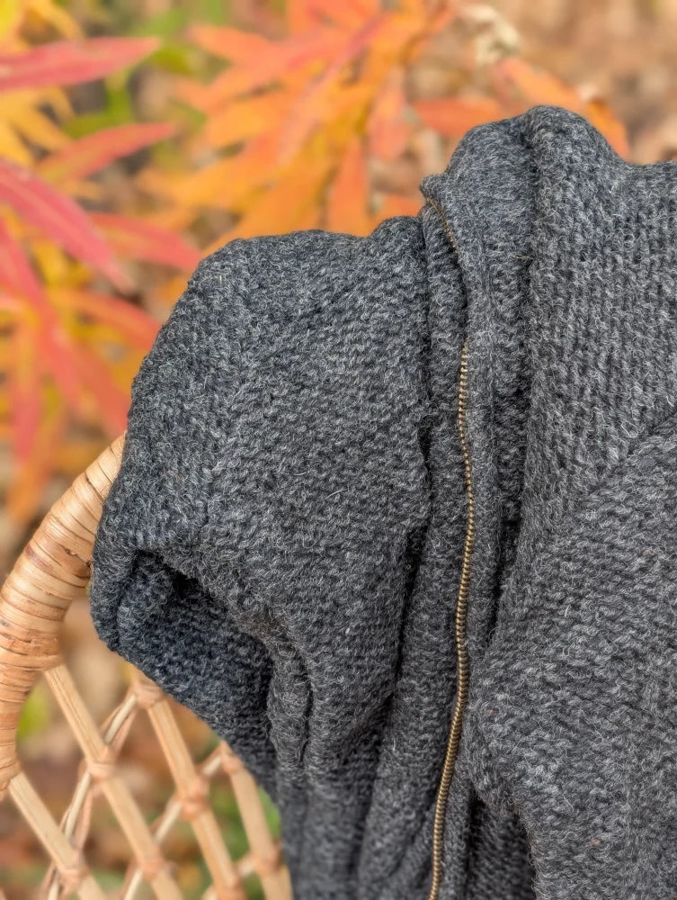 Cozy dark gray calgary cardigan with chunky knit pattern attached hood and gold-toned zipper made from zealand wool