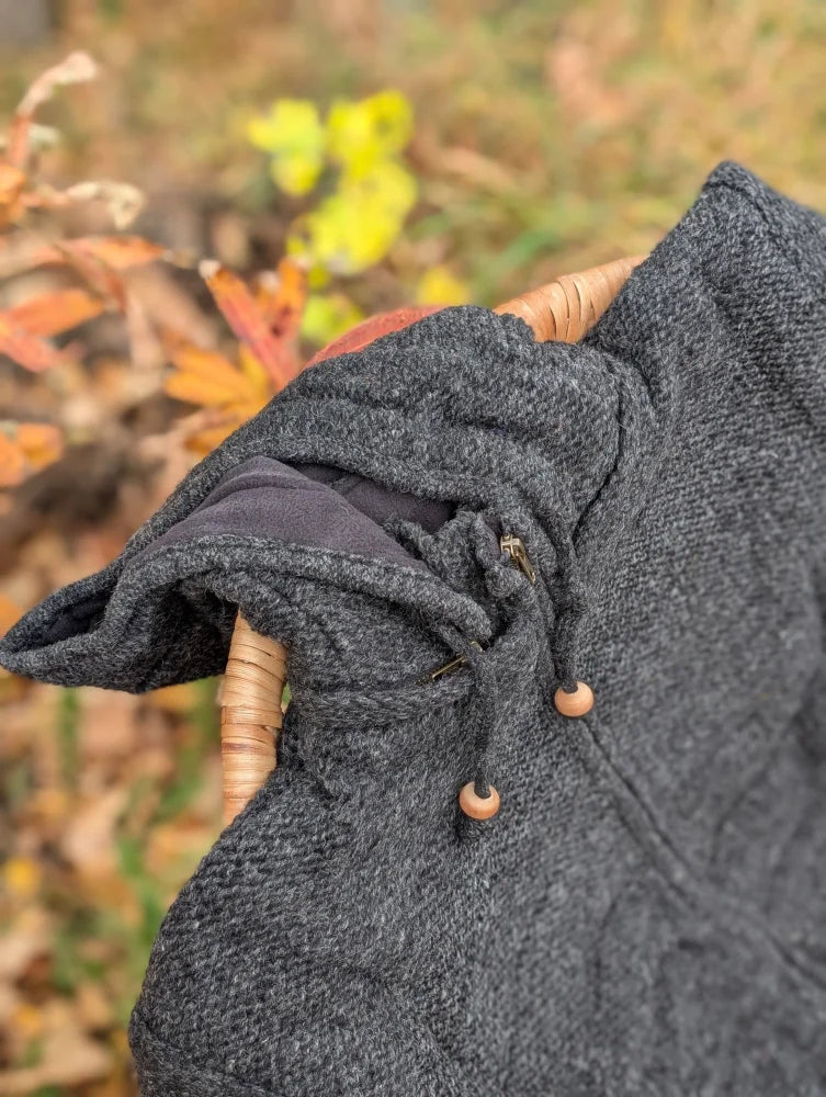 Dark gray calgary cardigan made of zealand wool with an attached hood and wooden toggle drawstrings
