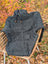 Dark gray calgary cardigan knit from zealand wool with attached hood wooden toggle drawstrings and ribbed cuffs