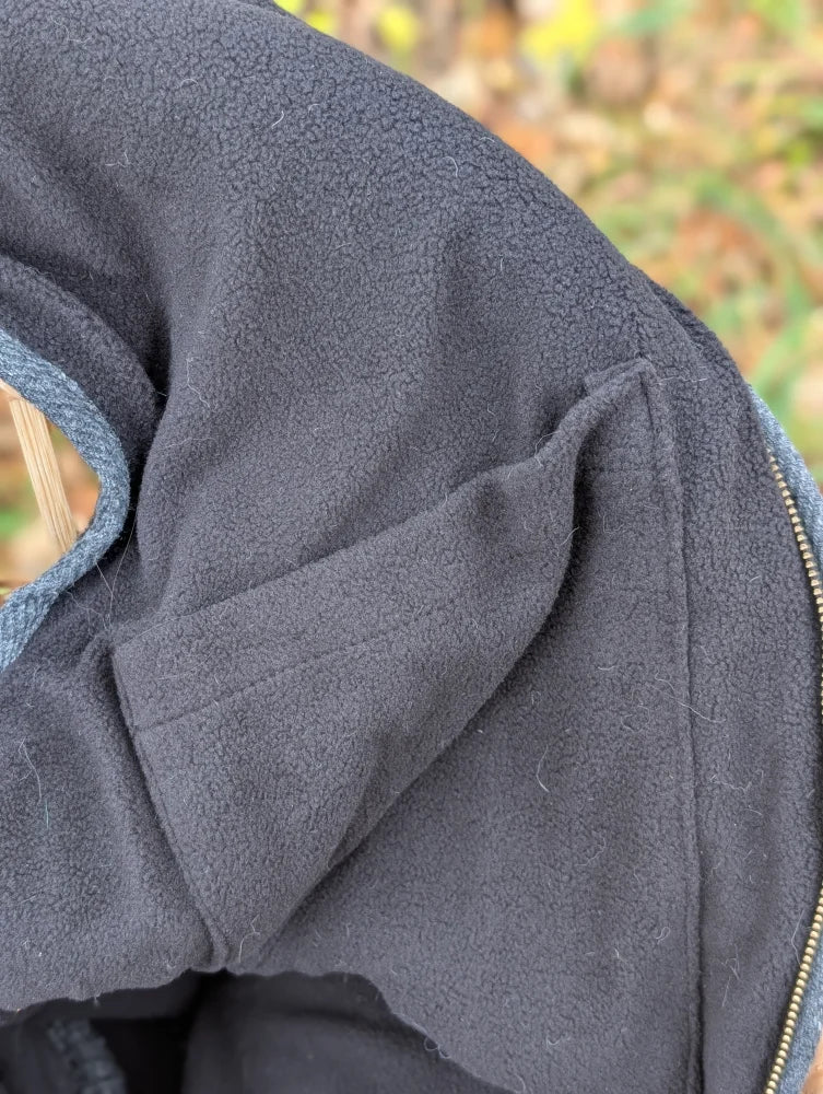 Dark gray woolen jasper vest with soft fleece and blue-lined hood perfect for cozy zealand wool warmth